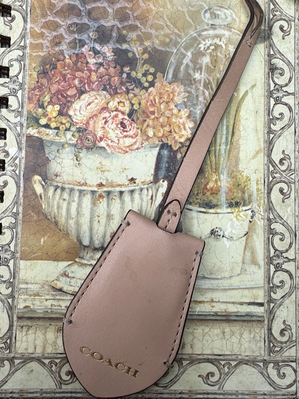 COACH hangtag with gold lettering. Two sided and a beige/light peach color.